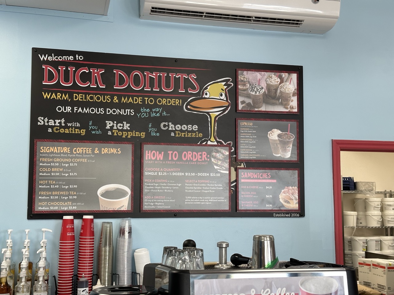 Menu board at a Duck Donuts shop