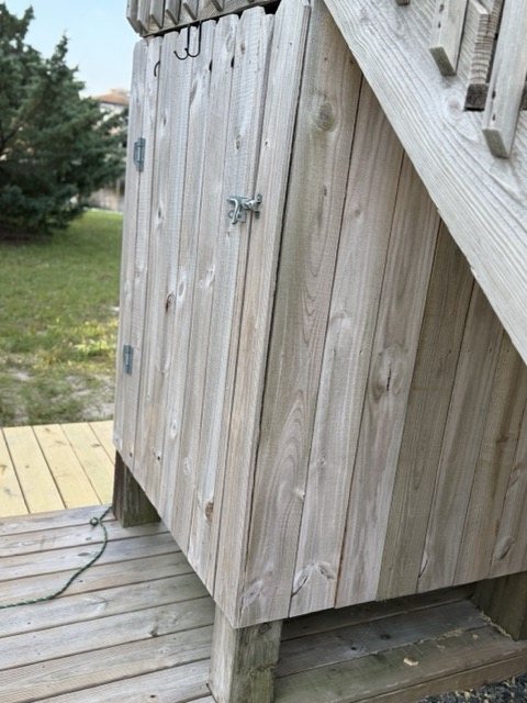 The enclosed outdoor shower at Lucky Landing, latched door