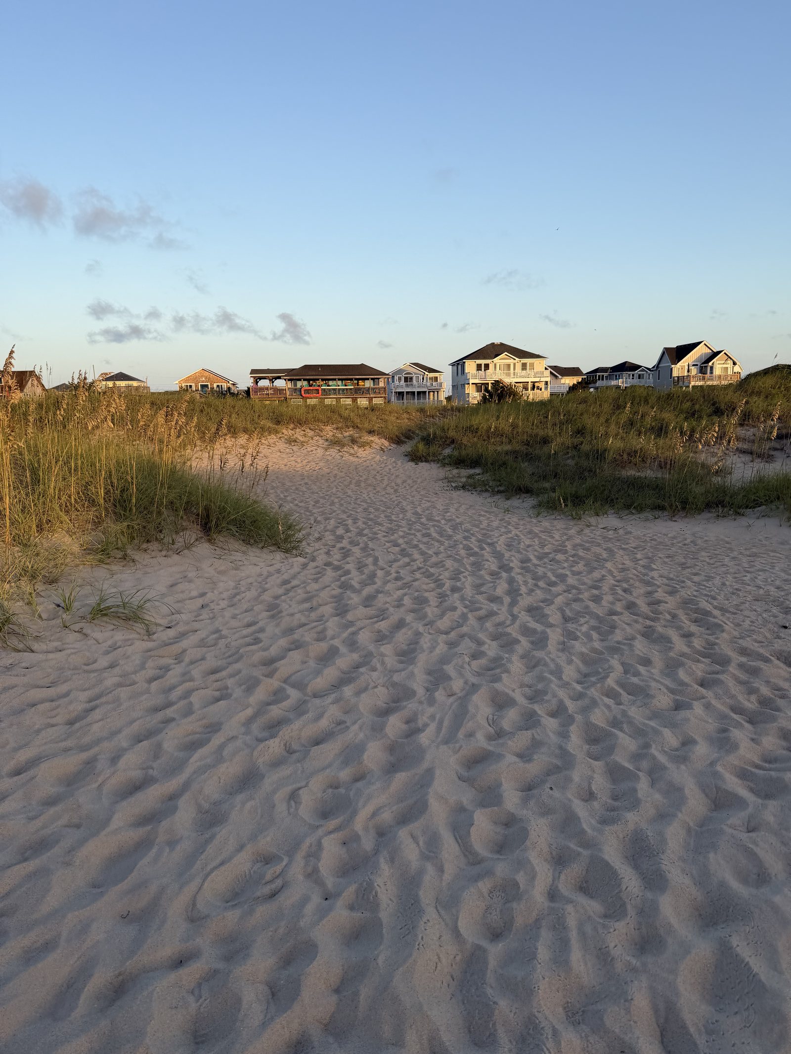 Sandy beach access path at golden hour in Avon