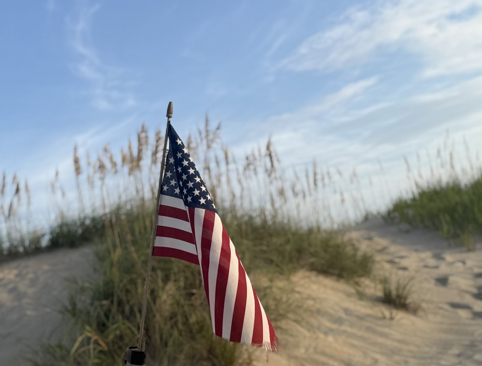American flag in the sea oats on the dune at golden hour in Avon