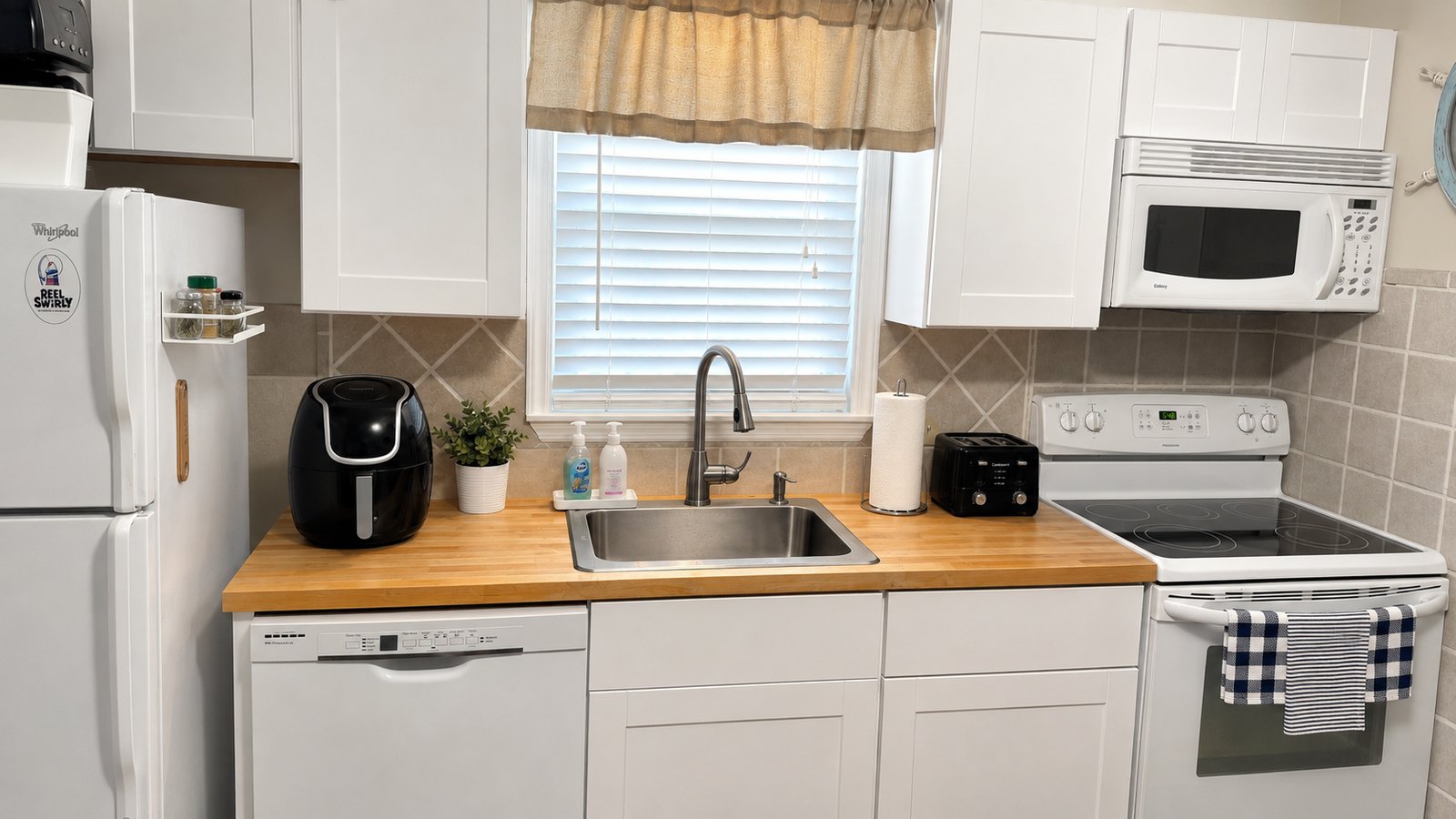 Bright, fully equipped kitchen with breakfast bar, air fryer, and full appliances at Lucky Landing